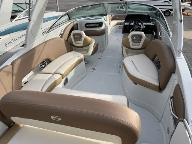Slide: The Image of 2023 Crownline 290 SS boat interior with beige and white seating. - 2