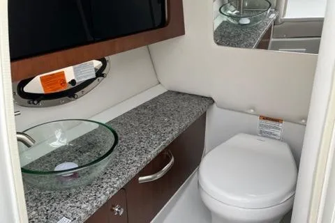 Slide: The Image of 2023 Crownline 290 SS boat bathroom with granite countertop and modern fixtures. - 7