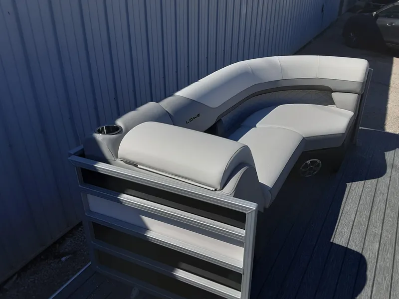 Slide: The Image of 2023 Lowe SS 230 pontoon boat with gray seating and cup holder. - 4