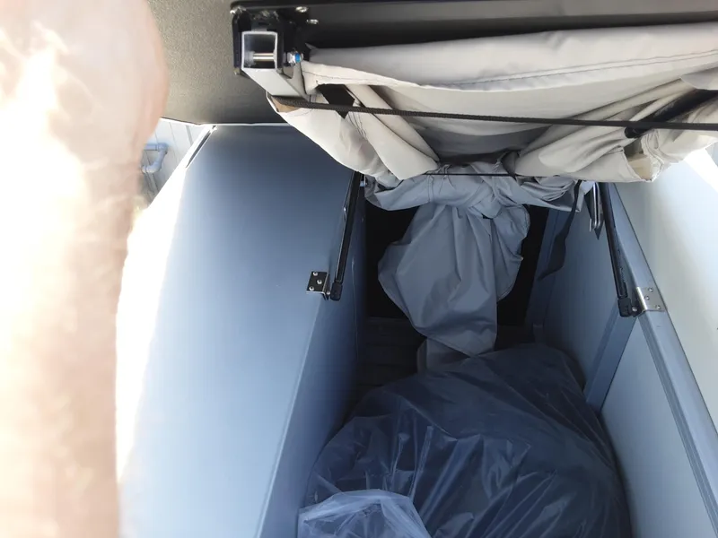 Slide: The Image of Interior storage compartment of 2023 Lowe SS 230 boat with covered items. - 8