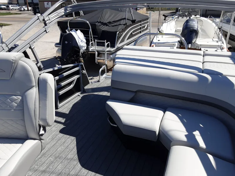 Slide: The Image of 2023 Lowe SS 230 pontoon boat interior with plush seating and modern design. - 9