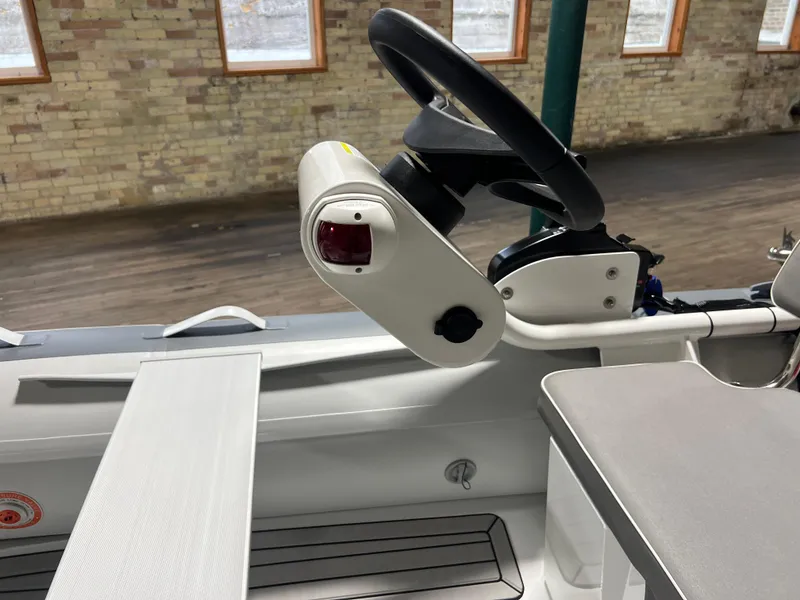 Slide: The Image of Steering console of 2023 Gala A330Q boat with black steering wheel and control panel. - 10