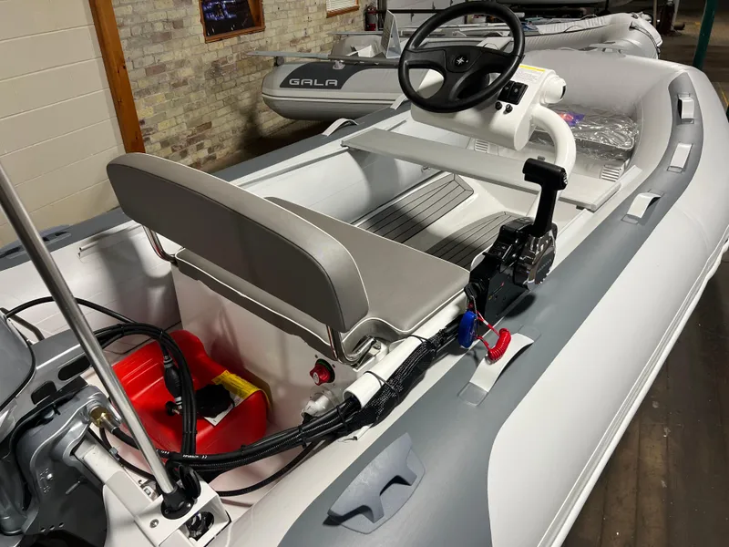 Slide: The Image of 2023 Gala A330Q inflatable boat with steering console and seating. - 2