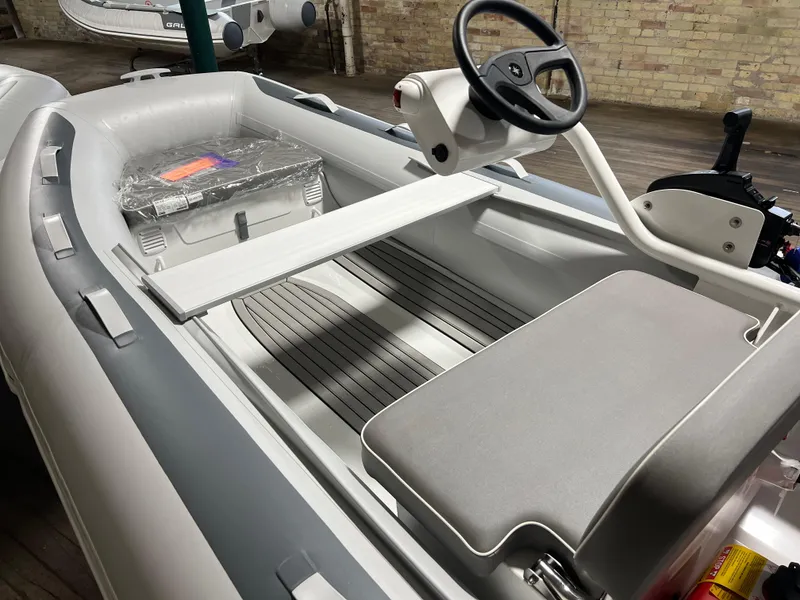 Slide: The Image of 2023 Gala A330Q inflatable boat interior with steering console and seating. - 4