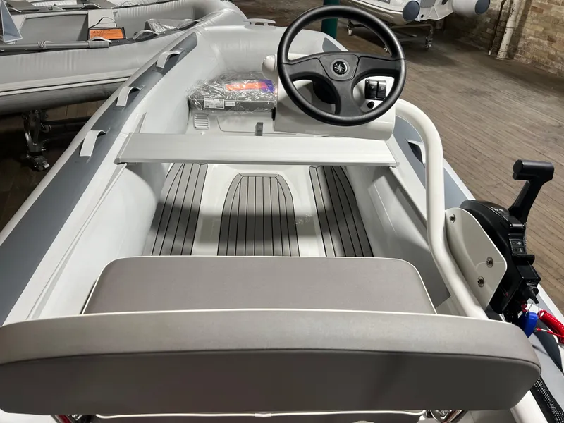 Slide: The Image of 2023 Gala A330Q inflatable boat interior with steering wheel and seating. - 5