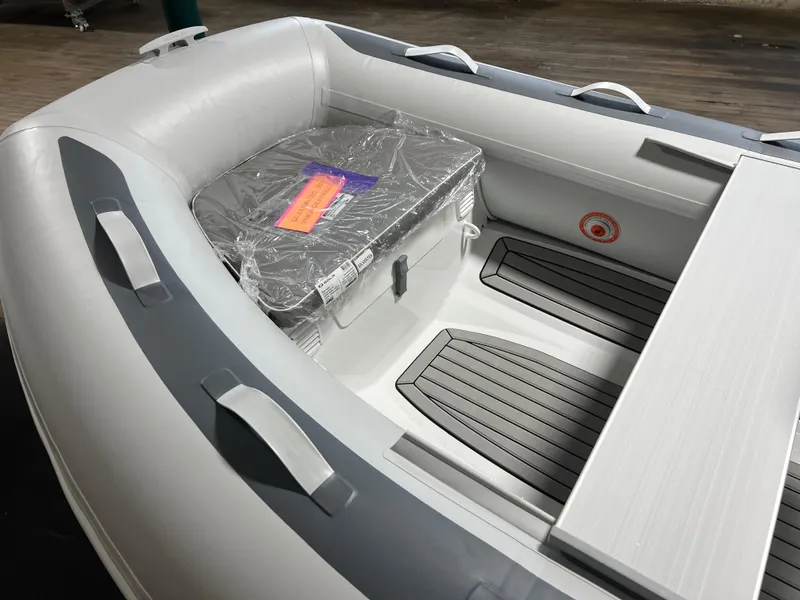 Slide: The Image of 2023 Gala A330Q inflatable boat interior with storage box and seating. - 7