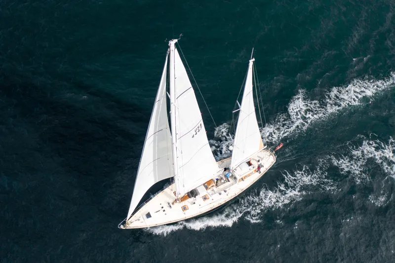 Slide: The Image of Aerial view of 1995 New England Boatworks Ketch sailing on open water. - 30