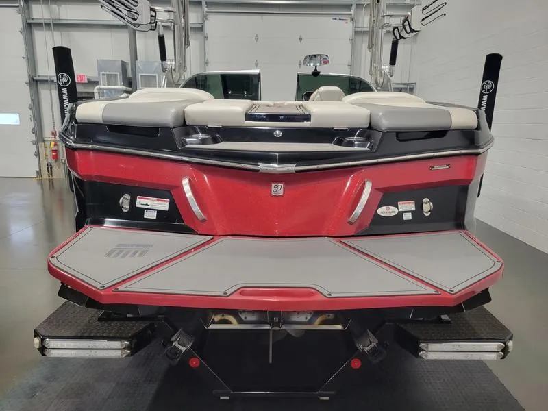 Slide: The Image of 2018 MasterCraft XT22 boat, rear view in a garage setting. - 11