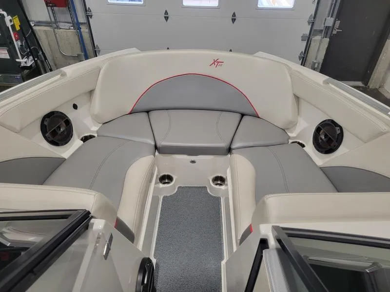 Slide: The Image of 2018 MasterCraft XT22 boat interior with gray and white seating. - 13