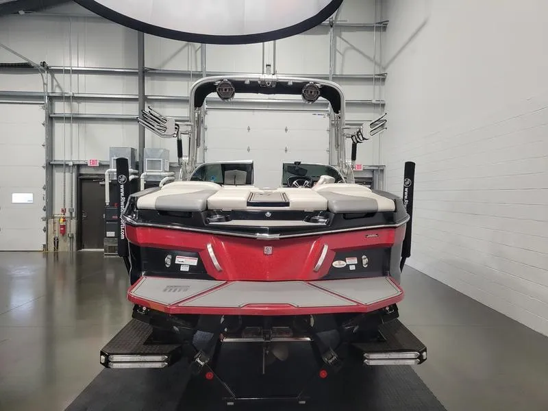 Slide: The Image of 2018 MasterCraft XT22 boat in a showroom, rear view. - 16