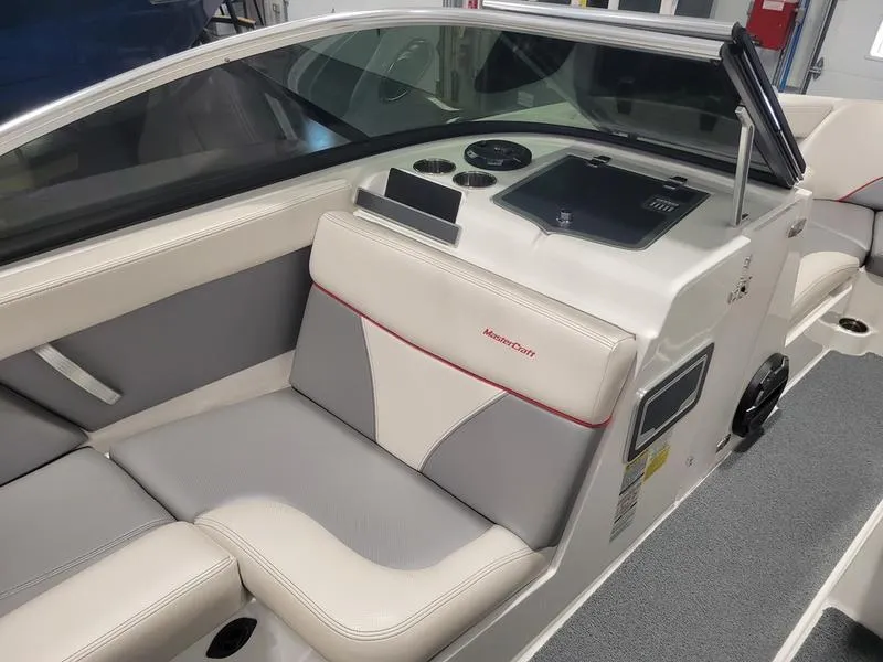 Slide: The Image of 2018 MasterCraft XT22 boat interior with beige and gray seating. - 17