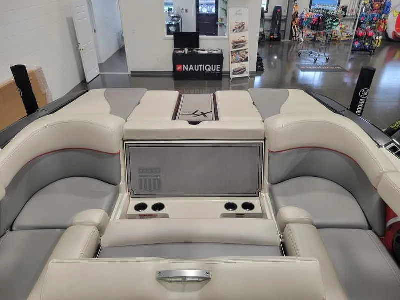 Slide: The Image of 2018 MasterCraft XT22 boat interior with cushioned seating and cup holders. - 18