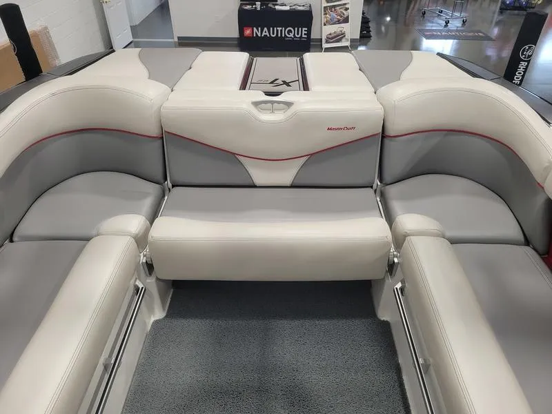 Slide: The Image of 2018 MasterCraft XT22 boat interior with gray and white seating. - 19