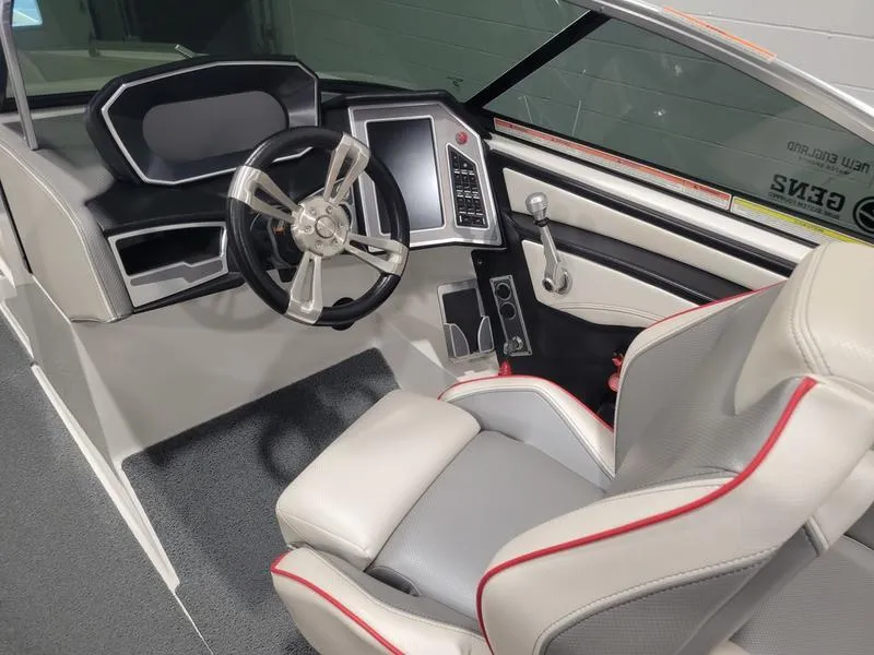 Slide: The Image of 2018 MasterCraft XT22 boat interior with steering wheel and control panel. - 21