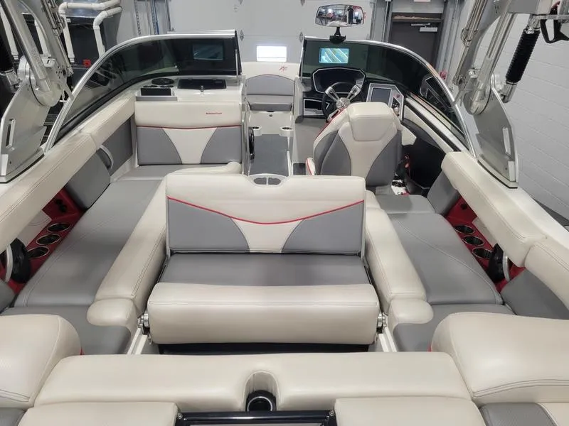 Slide: The Image of 2018 MasterCraft XT22 boat interior with gray and white seating, modern design. - 22
