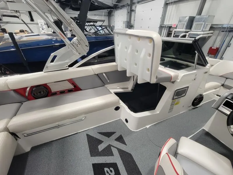 Slide: The Image of 2018 MasterCraft XT22 boat interior with white seating and modern design. - 23