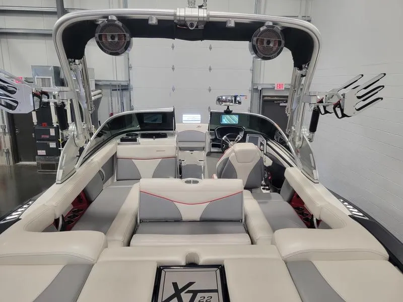 Slide: The Image of 2018 MasterCraft XT22 boat interior with seating and wakeboard racks. - 25