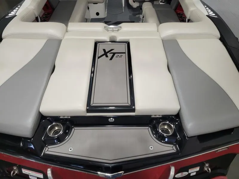 Slide: The Image of 2018 MasterCraft XT22 boat interior with cushioned seating and sleek design. - 26
