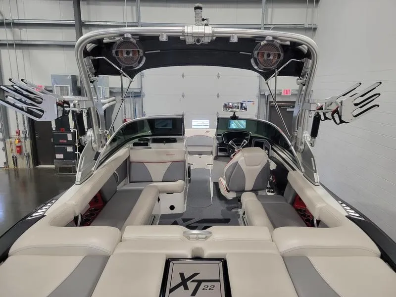 Slide: The Image of 2018 MasterCraft XT22 boat interior with seating and wakeboard racks. - 27