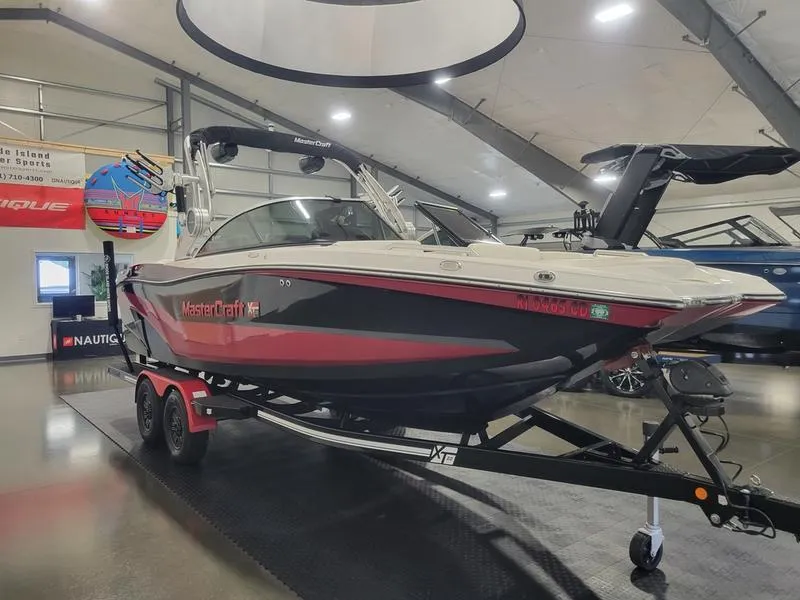 Slide: The Image of 2018 MasterCraft XT22 boat on display in a showroom. - 3