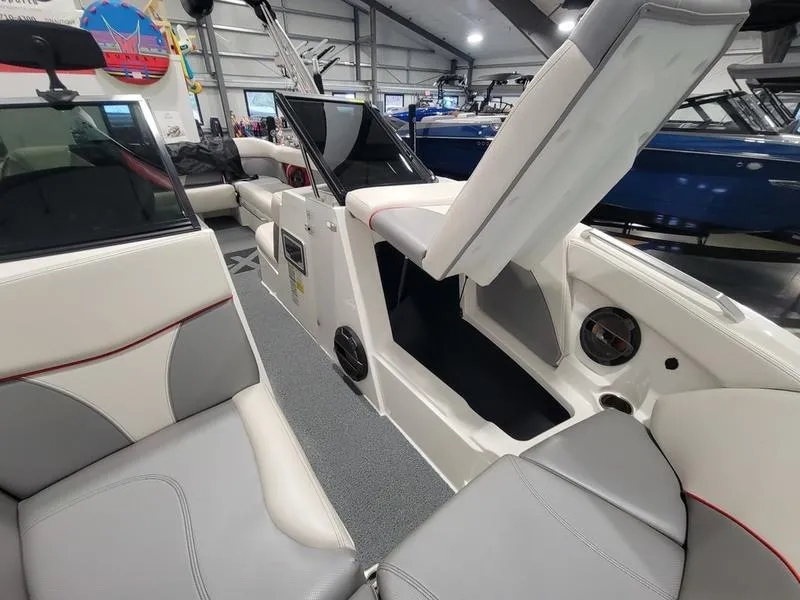 Slide: The Image of 2018 MasterCraft XT22 boat interior with open storage compartment and seating. - 5