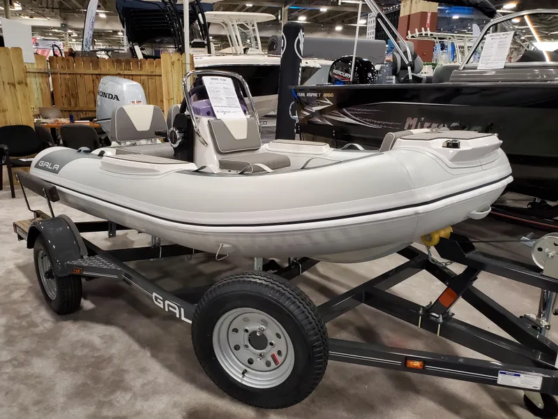 Slide: The Image of 2023 Gala V330 inflatable boat on a trailer at a boat show. - 0