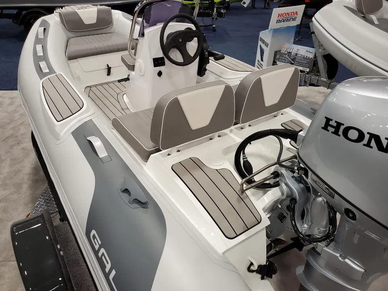 Slide: The Image of 2023 Gala V330 boat with Honda outboard motor at a marine exhibition. - 2
