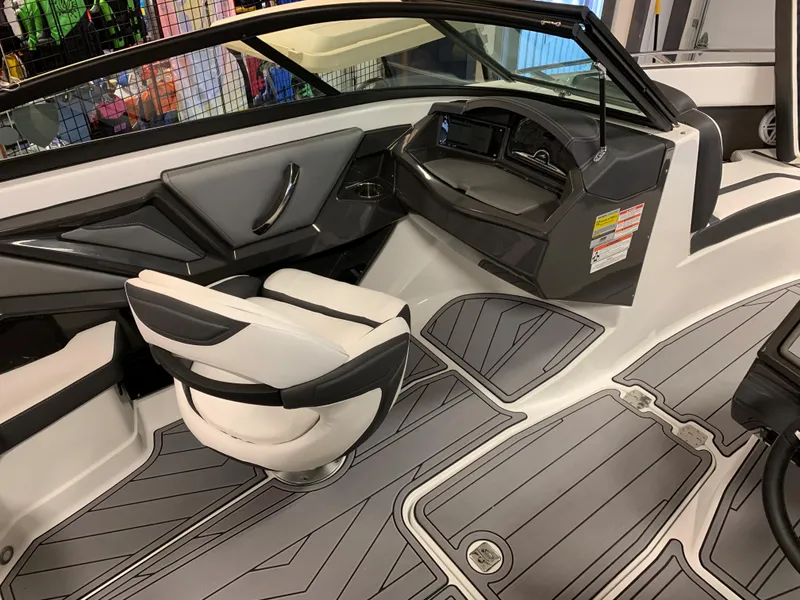 Slide: The Image of 2023 Monterey 218 Super Sport boat interior with sleek seating and modern dashboard design. - 11