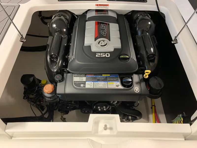 Slide: The Image of Engine compartment of a 2023 Monterey 218 Super Sport boat, featuring a 250 horsepower engine. - 14