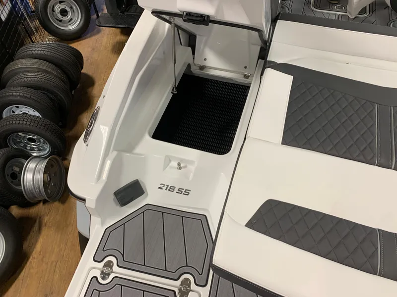 Slide: The Image of 2023 Monterey 218 Super Sport boat interior with gray and white seating and flooring. - 4
