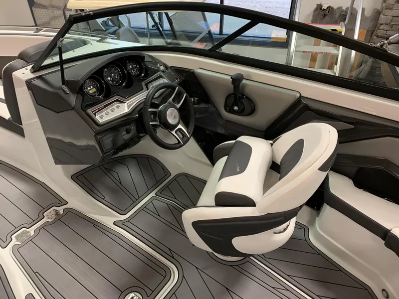Slide: The Image of 2023 Monterey 218 Super Sport boat interior with modern dashboard and seating. - 9