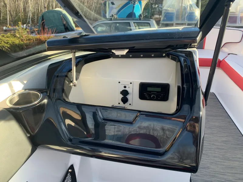Slide: The Image of 2023 Scarab 195 ID boat dashboard with open storage compartment. - 15