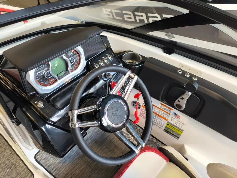Slide: The Image of 2023 Scarab 195 ID boat dashboard with steering wheel and control panel. - 17