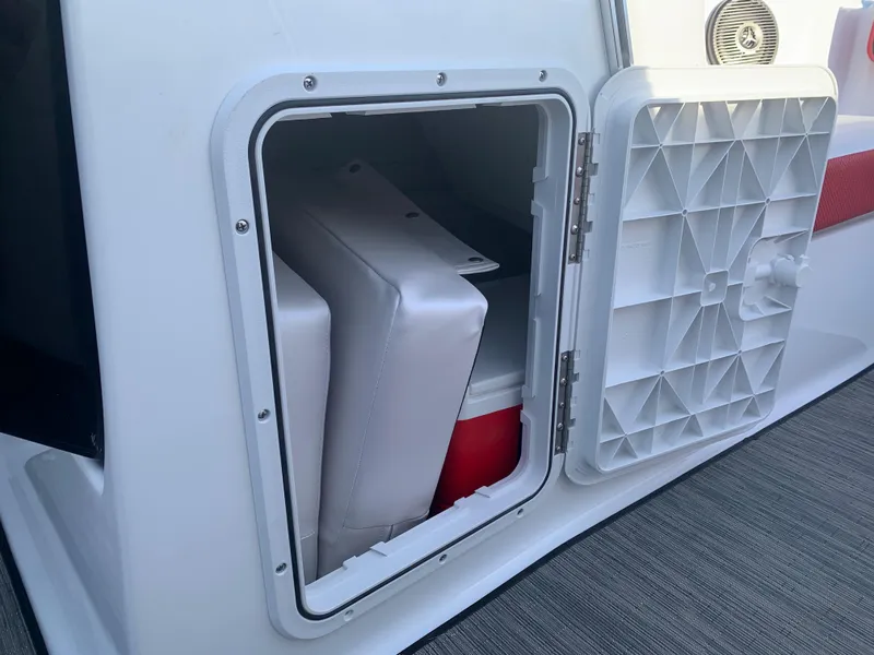 Slide: The Image of Storage compartment of 2023 Scarab 195 ID boat with cooler and cushions. - 19