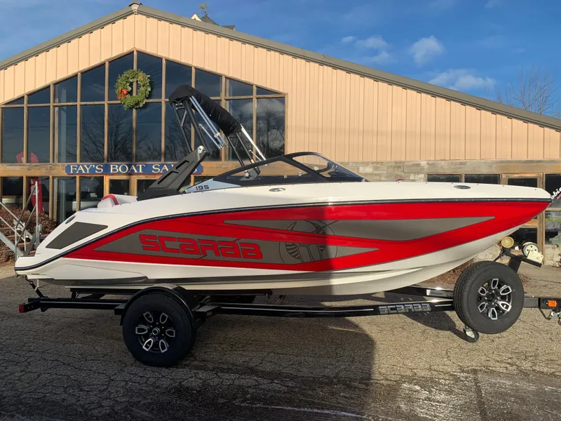 Slide: The Image of 2023 Scarab 195 ID boat on trailer outside Fay's Boat Sales. - 2
