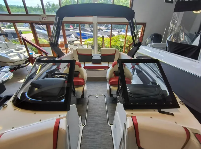 Slide: The Image of 2023 Scarab 195 ID boat interior with red and white seating, showroom display. - 20