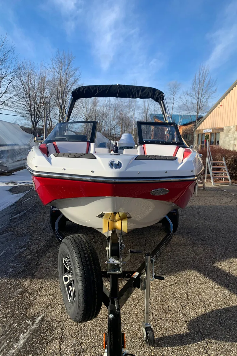 Slide: The Image of 2023 Scarab 195 ID boat with red and white exterior on a trailer. - 3
