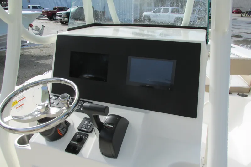 Slide: The Image of 2023 Sea Born LX22 Center Console dashboard with steering wheel and controls. - 11