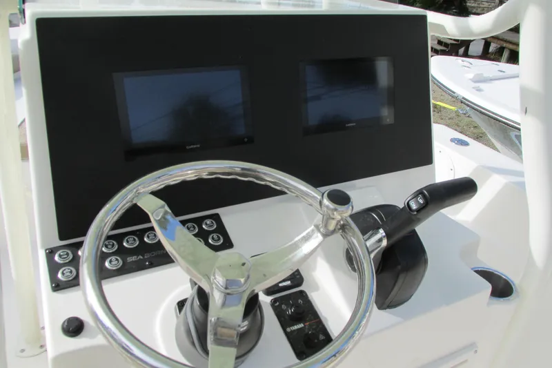 Slide: The Image of 2023 Sea Born LX22 Center Console dashboard with dual screens and steering wheel. - 12
