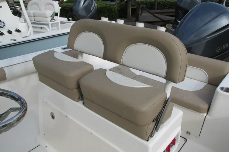 Slide: The Image of 2023 Sea Born LX22 Center Console boat seating with beige and white cushions. - 15