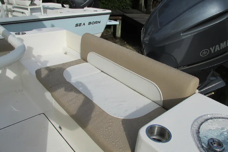 Slide: The Image of 2023 Sea Born LX22 Center Console boat with beige seating and Yamaha engine. - 18