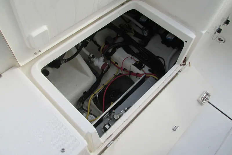 Slide: The Image of 2023 Sea Born LX22 Center Console storage compartment with wiring and equipment. - 19