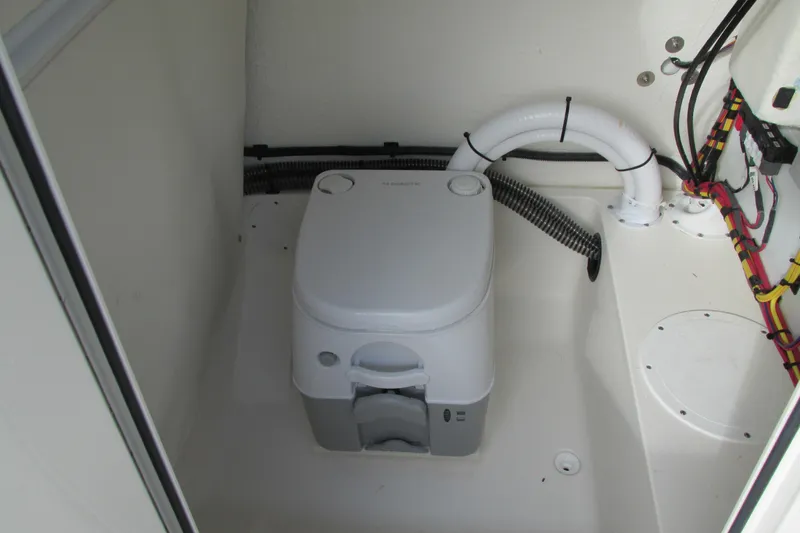 Slide: The Image of 2023 Sea Born LX22 Center Console boat interior with portable toilet. - 21