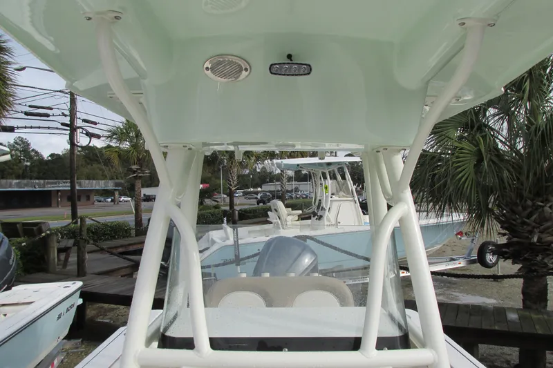 Slide: The Image of 2023 Sea Born LX22 Center Console boat with T-top, parked outdoors. - 26
