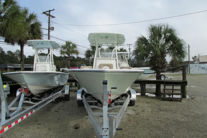 Slide: The Image of 2023 Sea Born LX22 Center Console boats on trailers, parked outdoors. - 3