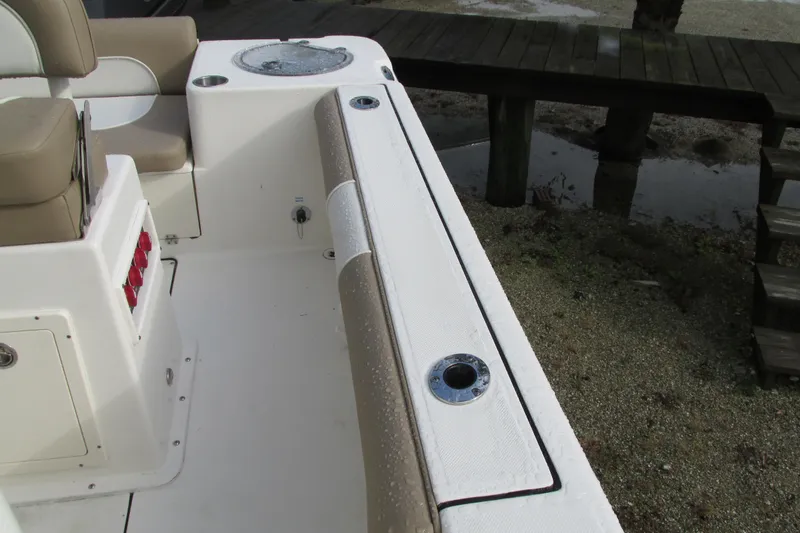 Slide: The Image of 2023 Sea Born LX22 Center Console boat interior with seating and rod holders. - 32