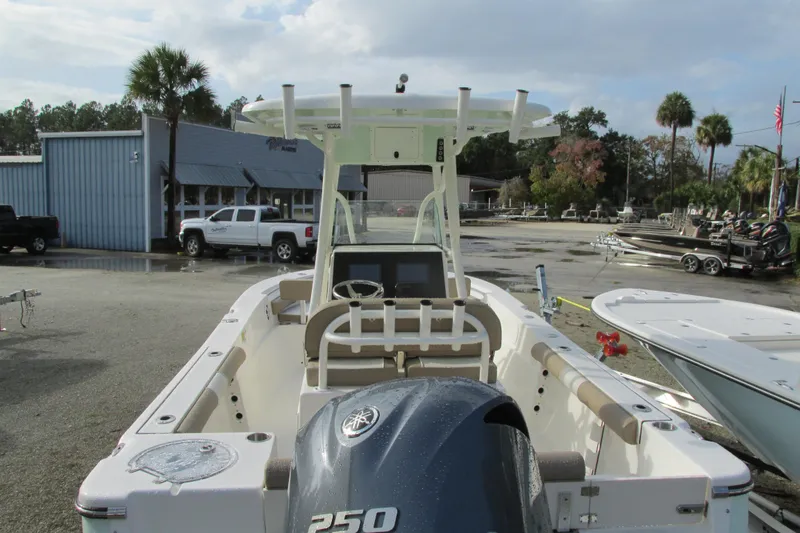 Slide: The Image of 2023 Sea Born LX22 Center Console boat with Yamaha 250 engine in a marina setting. - 6