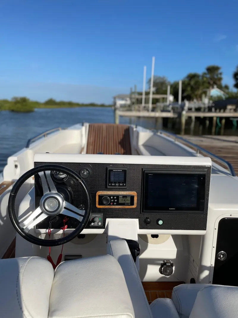 Slide: The Image of 2011 Novurania Chapman Transition 28 boat cockpit with steering wheel and navigation equipment. - 14