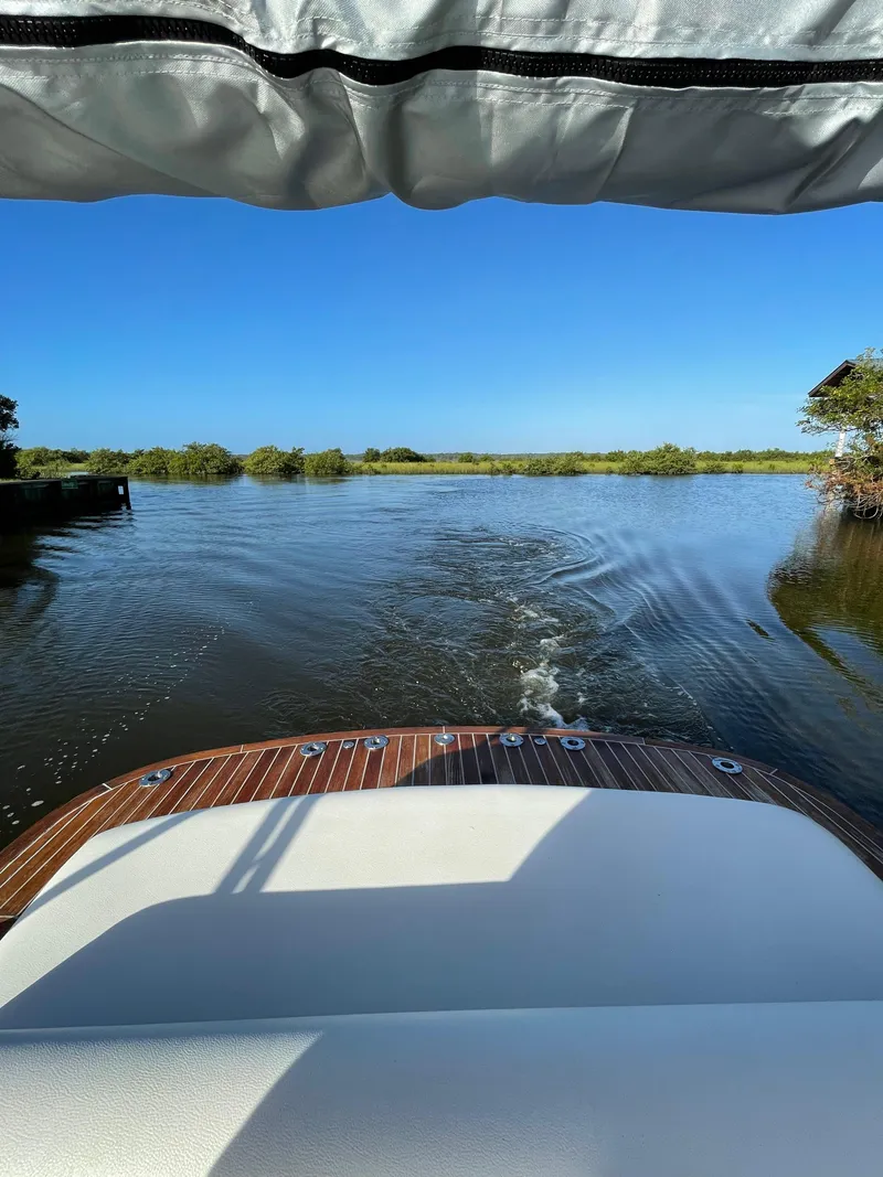 Slide: The Image of Novurania Chapman Transition 28 boat cruising on a calm river, 2011 model. - 17