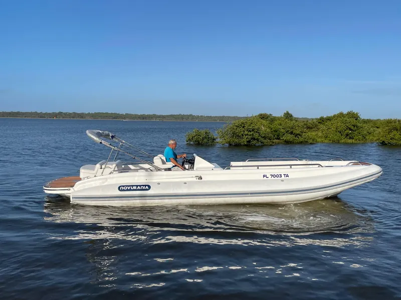 Slide: The Image of 2011 Novurania Chapman Transition 28 boat cruising on calm water. - 20